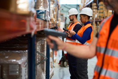 A real photo of a technician or warehouse worker using a handheld, or a real Neptune screenshot.